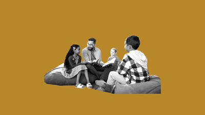 Adult and group of children talking