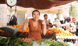 Positive woman in farmer's market