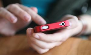 person's hands scrolling through smartphone screen