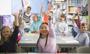 students with arms raised 