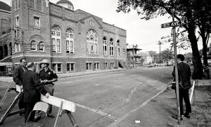 A STATE TROOPER GUARDS A ROAD BLOCK AT THE 16TH STREET BAPTIST CHURCH THE DAY AFTER THE BOMBING.