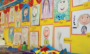 Children's self-portraits hanging on a wall