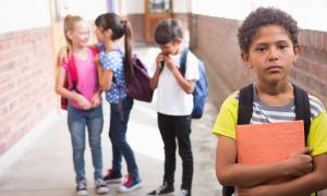 boy standing outside of group of children