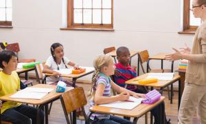 elementary teacher talking with students