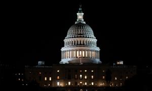 The United States Capitol building illuminated at night.