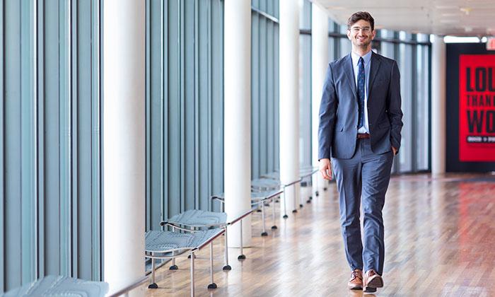 Benjamin Marcus walks down a hallway