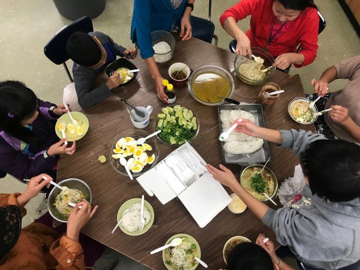 Parents and students cooking in the Culturally Inclusive Cooking Club