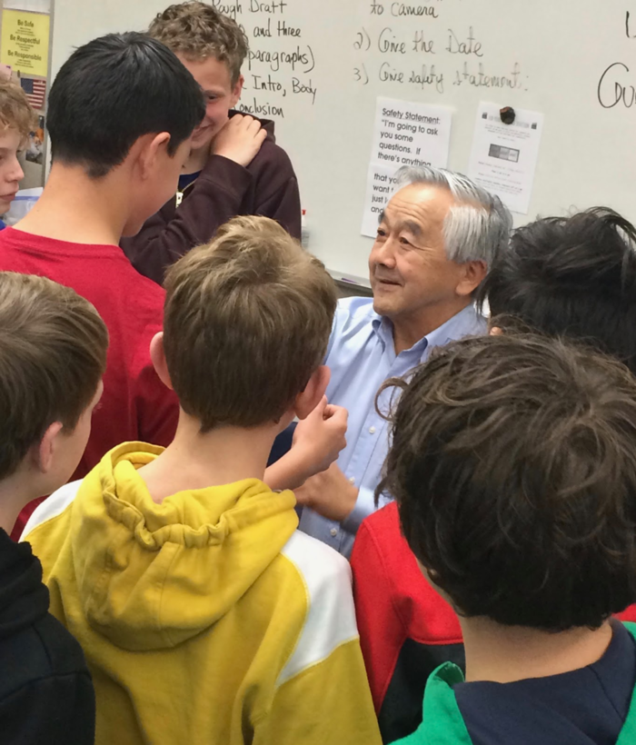 Several students in Santa Rosa classroom chatting with interviewee.